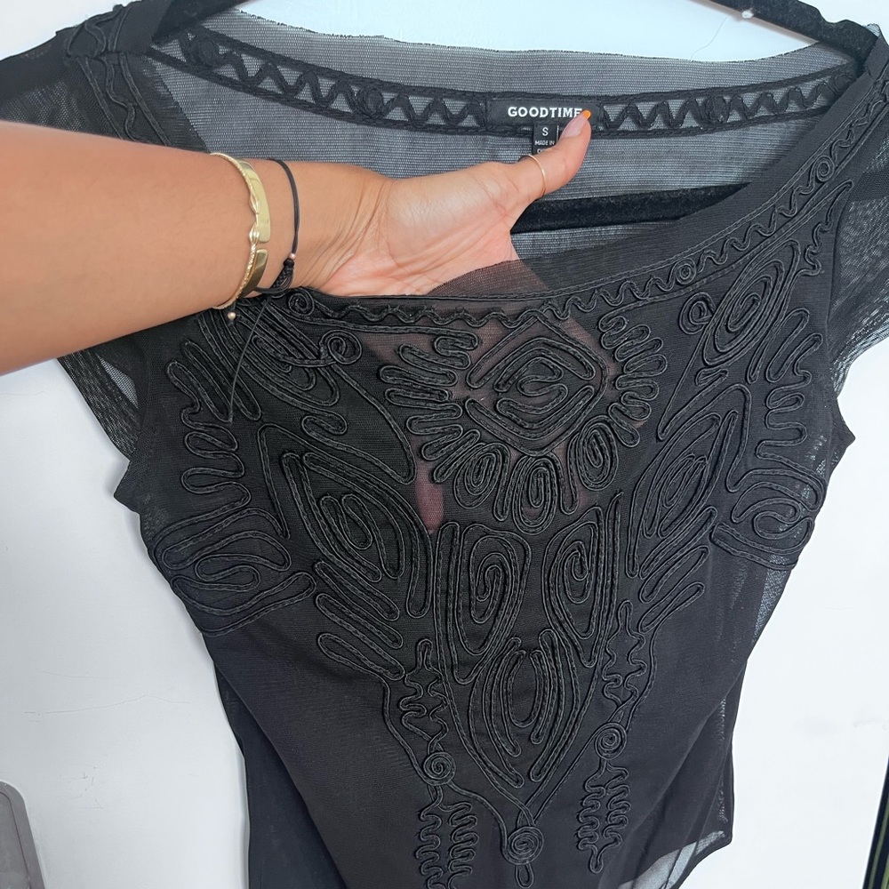 Black sheer body suit. Size 2 lace design.